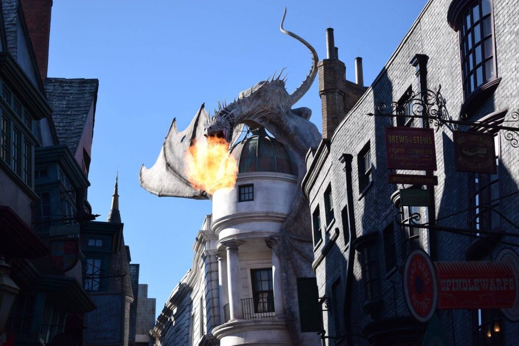 At the Escape from Gringotts ride at Universal Orlando Resort, a dragon breaths fire over the heads of guests.